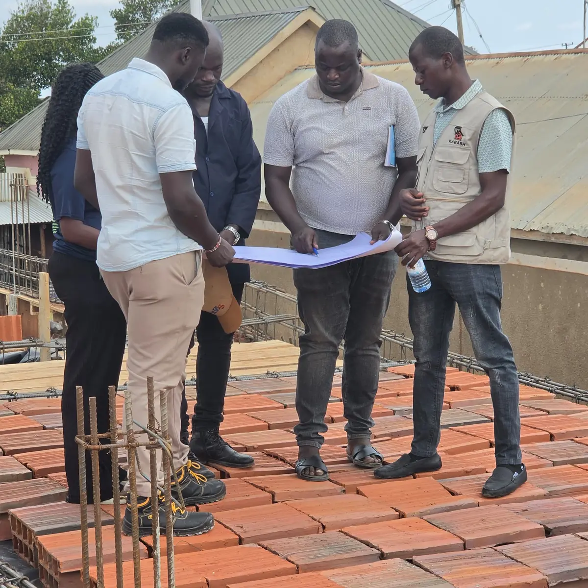 Kabash team reviewing construction drawings during an on-site inspection